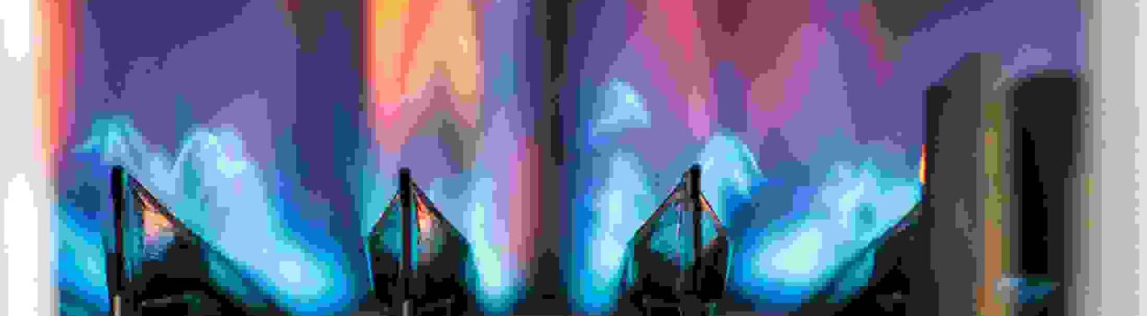 Flames ignited to heat water as seen through a gas boiler's viewing window.
